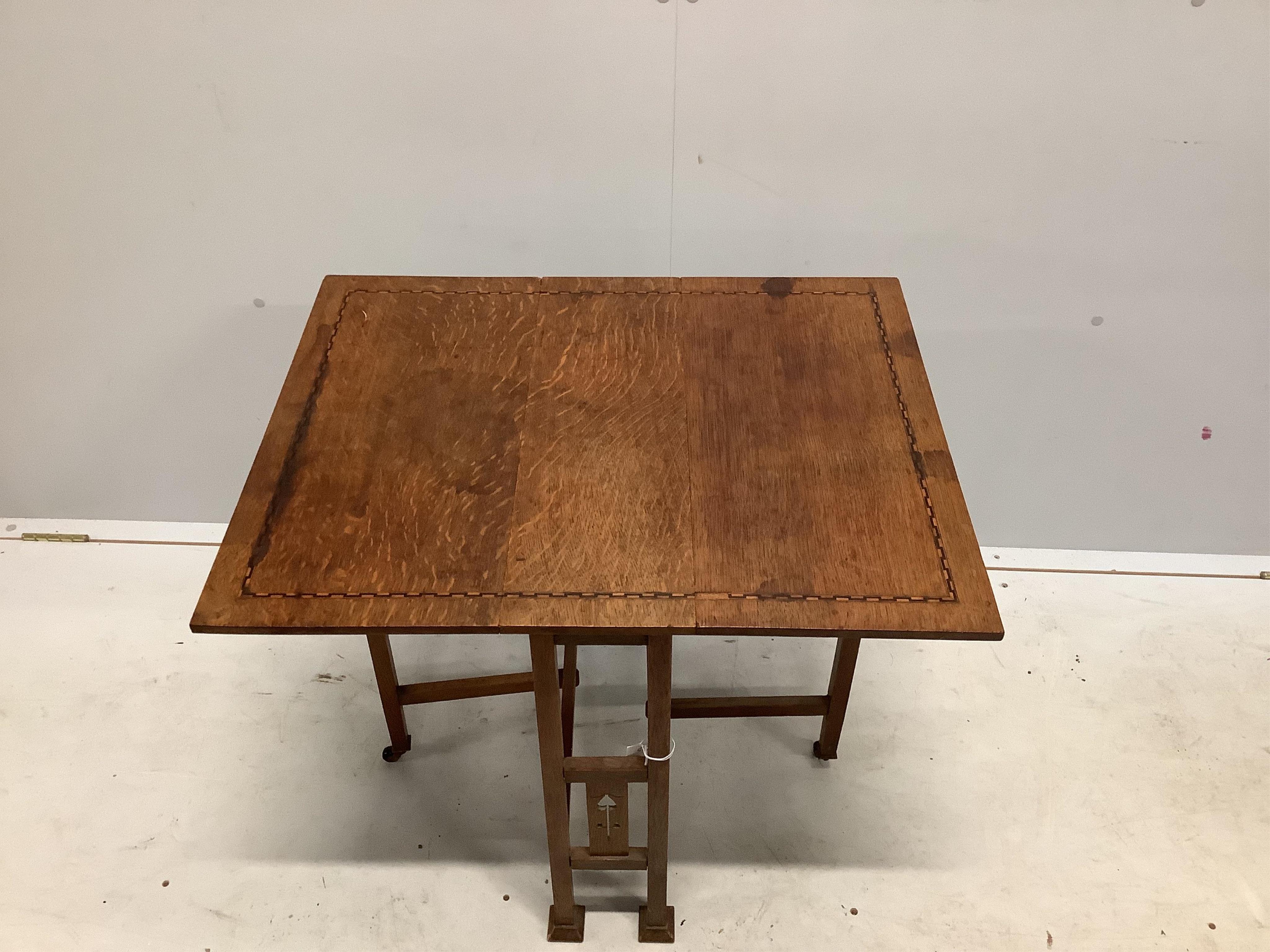 An Arts & Crafts inlaid oak Sutherland table, width 56cm, depth 20cm, height 60cm. Condition - fair